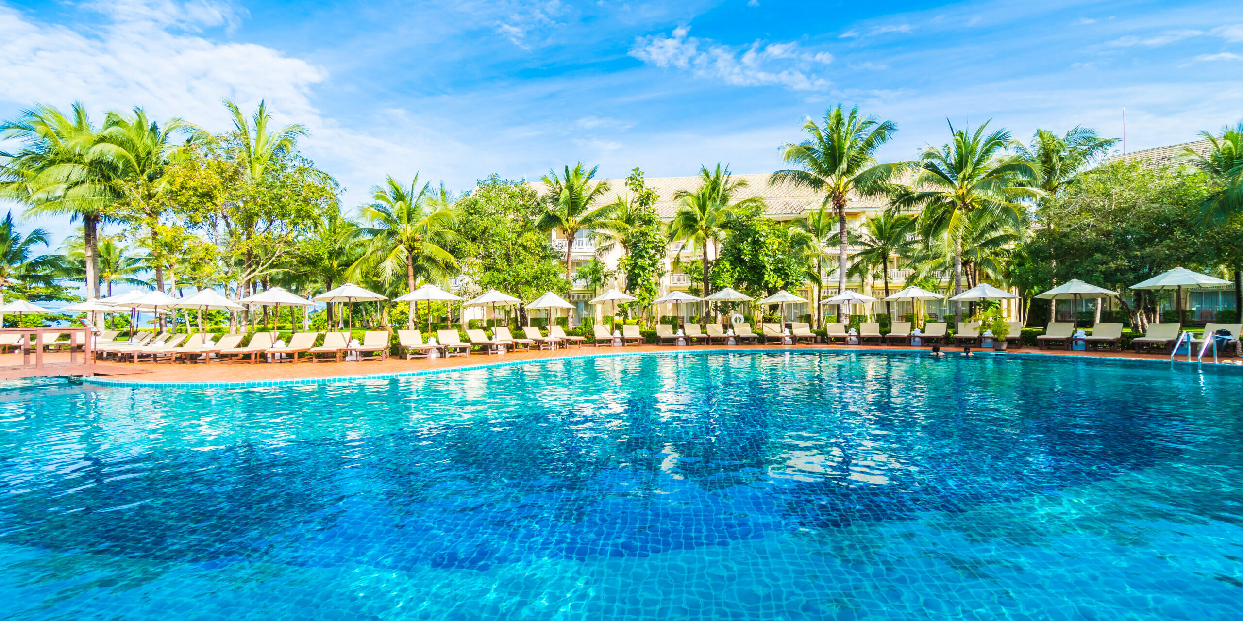 Umbrella and chair around swimming pool